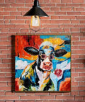 Cool Cow Portrait With Sunglasses Modern Hand Painted Textured Wall Art Framed Cow Head Floral Canvas Bold Black White Red Blue Colorway For Living Room Bedroom Or Bath A Fresh Totally Vibey Statement Piece hanging on brick wall