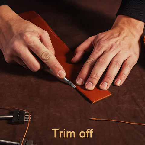 Using Six Piece Leather Edge Tool Kit with four graded edge bevelers, skiving knife shown trimming leather strip for crafts.
