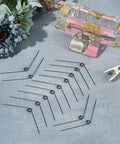30 Pcs Stainless Steel Torsion Springs 0.5mm Wire Diameter 4.5mm Outer Diameter 120 Degree Deflection arranged on table.