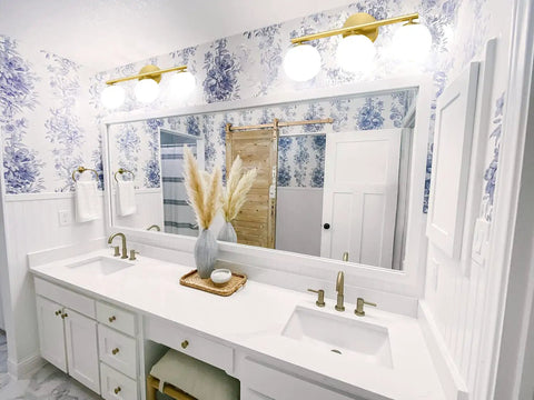 Rock A Stylish Mid Century Modern Vibe In Your Bathroom With These Three Light Gold Vanity Fixtures Complete With Frosted Milk Glass Globes And A Brushed Gold Frame That Is Dimmable Wall Mount Ready positioned above double sinks in modern bathroom