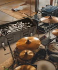 Road Ready Drum Hardware Case With Wheels And Telescoping Handle Featuring Hella Durable Roto Molded Polyethylene Construction Secure Cinch Straps For Stands Pedals And Gear Hauling Black filled with drum hardware in studio setting.
