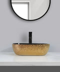 USZWBY Vessel Sinks Ceramic Vessel Sink Light Luxury Household Single Basin with gold finish on countertop near a mirror.