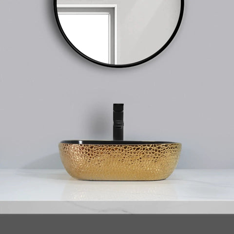 USZWBY Vessel Sinks Ceramic Vessel Sink Light Luxury Household Single Basin with gold finish on countertop near a mirror.