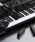 6.35mm Ground Loop Noise Isolator For Guitar Amp And Mixer 1/4 Inch Hum Eliminator next to keyboard and microphone setup