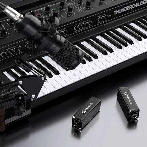 6.35mm Ground Loop Noise Isolator For Guitar Amp And Mixer 1/4 Inch Hum Eliminator next to keyboard and microphone setup
