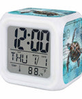 Super Chill Digital Cube Alarm Clock With Quiet Sweep Motion Dreamy Ocean Turtle Graphic Retro Stamp Accents blue display showing time and temperature.