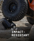 Off-road vehicle tire on Vault V100 Tough As Nails Multi Purpose Hard Case With Foam showing crushproof in OD Green