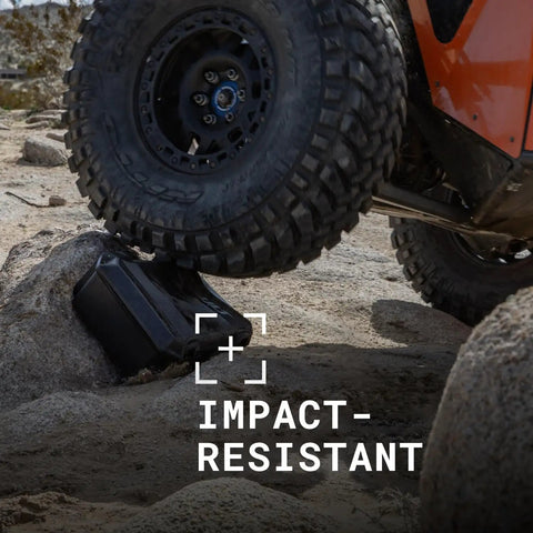 Off-road vehicle tire on Vault V100 Tough As Nails Multi Purpose Hard Case With Foam showing crushproof in OD Green