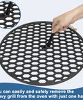 Heavy Duty Cast Iron Grill Grate Lifter lifting a round grill grate, shown in use for easy lifting of heavy grates on grills.
