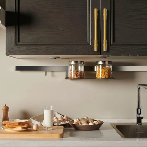 Kitchen scene with 2 Pack Solid Brass Gold Cabinet Pulls With 3 And 3 Quarters Inch Center To Center on dark cabinets above a countertop.