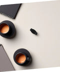 Espresso Steam Wand Heat Insulation Sleeve Anti Burn Rubber Wrap For Coffee Machines next to black coffee cups on table