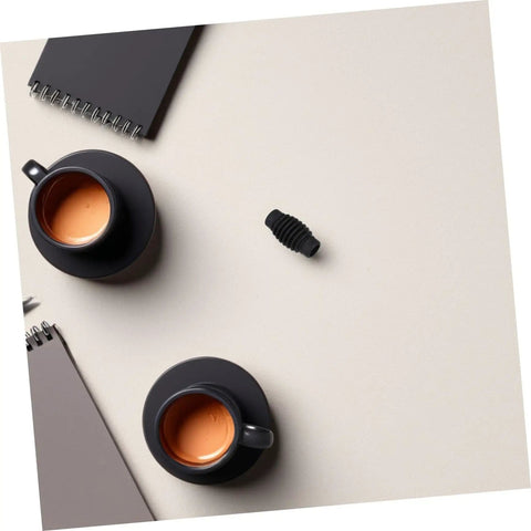 Espresso Steam Wand Heat Insulation Sleeve Anti Burn Rubber Wrap For Coffee Machines next to black coffee cups on table
