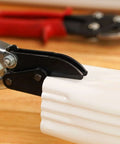 Close-up of 5-Blade Crimper For Straight And Wide Cut Pinch-Thru Point Cutter in use, showing hardened steel blades on downspout pipe