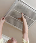 Person installing 24 By 10 Steel Return Air Filter Grille For 1 Inch Filter With Removable Face Door Built Like A Tank for duct cover.
