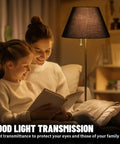 Barrel Style Table Lamp Shade Replacement For Your Home Go To Natural Linen Black Lampshade illuminating a room with book readers