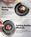 Zero Hassle Kitchen Sink Drain Strainer Featuring A Patent Flip Bottom Design And Sleek Black Chain Mesh Basket catching food scraps in stainless steel sink.