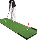 Person practicing on Indoor Outdoor 3x10ft Golf Putting Green Mat With Thick 10mm Non Slip Base And Side Borders Portable Three Hole Design Movable Cup For Home Backyard Or Office Practice Realistic Turf