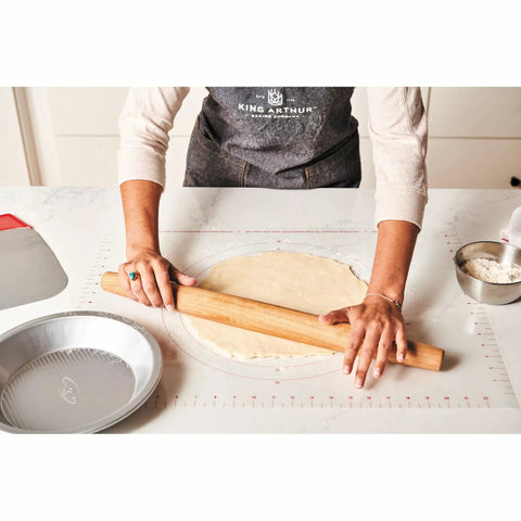 Person using Non Slip Silicone Rolling Mat For Dough Kneading And Rolling Nonstick Surface For Measuring And Baking.