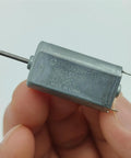 Close-up of Mini 050 DC Motor 15mm Micro Electric Motor with Precious Metal Brush for robotics and RC projects.