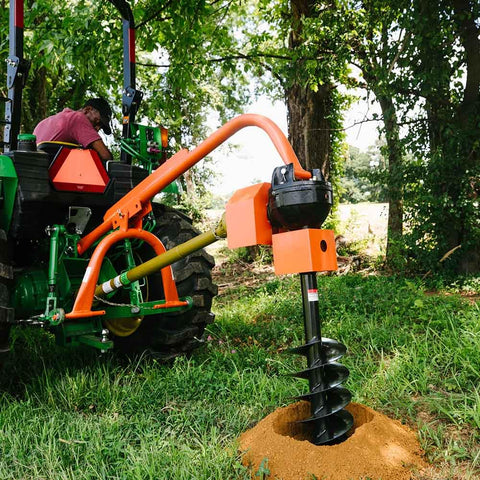 60 HP 3-Point Post Hole Digger Attachment for Category 1 Tractors, PTO driven auger in action drilling a hole in grass.