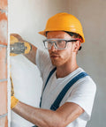 Worker using drill while wearing Over Glasses Safety Goggles With Anti Fog And Scratch Resistant Lenses ANSI Z87 Certified