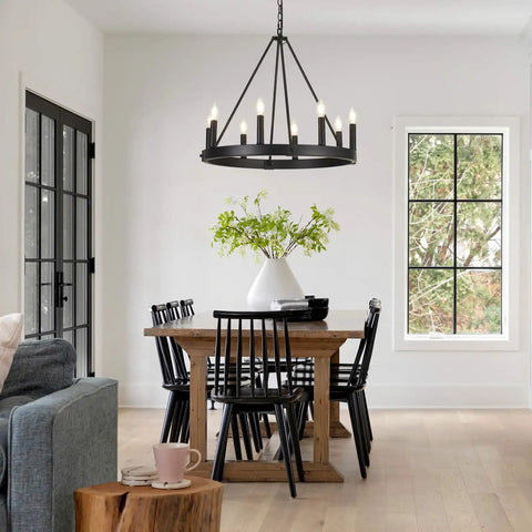 Eight-Light Wagon Wheel Chandelier in Black hanging over a dining table, showcasing farmhouse meets modern industrial style.