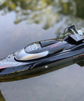 Eighteen Inch Brushless RC Speed Boat With Two Four GHz Remote Control Four Wheel Drive Watercraft gliding on calm water surface
