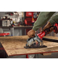 Heavy Duty 4.5 Inch Cordless Circular Saw With Brushless Motor Punching Up To 4500 Rpm cutting through plywood on a workbench.