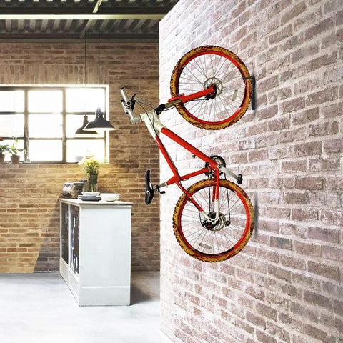 Garage Wall Mount Bike Hanger And Vertical Rack for easy hanging of red bike in a brick-walled kitchen, holds up to 65 pounds.
