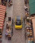 Premium Two Seater Electric Golf Cart Boasting A Killer 112 Mile Lithium Range Lightning Fast Four Hour Charging And High End Smart Cabin Features For Total Neighborhood Comfort driving through a quaint Parisian street.