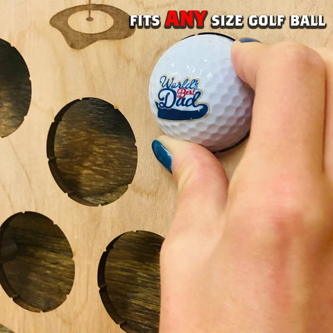 Hand placing ball in customizable golf ball display case wall mount holds 72 balls, perfect for collectors.