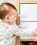 Baby near cabinet locked with 12 Pcs White ABS Cabinet Locks For Kidproofing Drawers And Appliances With Easy Install And Reliable Security Plus Adjustable Furniture Straps For Home Safety