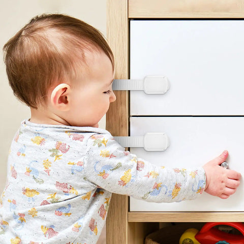 Baby near cabinet locked with 12 Pcs White ABS Cabinet Locks For Kidproofing Drawers And Appliances With Easy Install And Reliable Security Plus Adjustable Furniture Straps For Home Safety