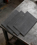 Three Piece Rectangle Graphite Block Disk Set High Purity Graphite Electrode Plate Sheet on workbench