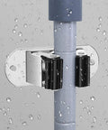 Heavy Duty Mop And Broom Wall Mount Organizer, Stainless Steel Tool Rack gripping a wet mop handle securely