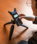 Pro On The Go Grab And Go 32 Bit Float Field Recorder With USB C Audio Interface on tripod, user adjusting settings