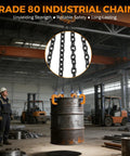 Front view of a drum lifter with four orange clamps and chains lifting a 55-gallon metal drum in a factory.