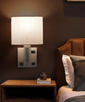Set of 2 Wall Sconces With USB Port And AC Outlet, Nickel Finish Bedside Lamps, shown in bedroom setting