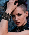 Dope Eight Piece Punk Rock Studded Leather Bracelet Set With Adjustable Spiked Zinc Cuffs worn on model's wrist.
