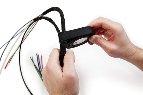 Person applying Temflex 1700 Vinyl Electrical Tape single roll 3/4 in x 60 ft Black PVC insulating tape on wires for splicing