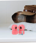 Pink wheels and metal screws from 18 Pack Roller Skate Brake Screws And Stopper Fittings For Inline And Quad Skates, on fabric surface.