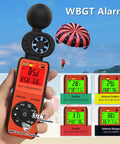 Handheld Heat Stress Meter And Anemometer With WBGT, Wind Speed 0 To 30 MPS, measuring at beach with parachute in background.