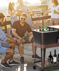 Group enjoying a party with an 80 Quart Rolling Patio Cooler Cart With Blackboard, Built In Bottle Opener on a rooftop deck.