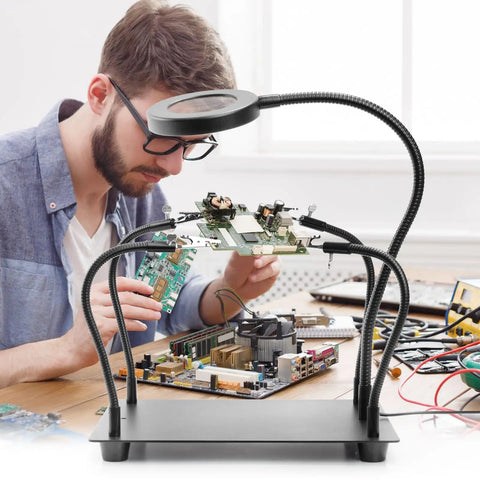 Four Arm Soldering Gear With 5X Magnifier And Light, PCB Holder And Third Hand Tool, Non Slip Steel Weighted Base in use on benchtop