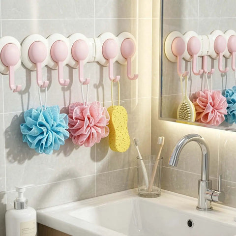 Heavy Duty Six Hook Adhesive Wall Rack With Smooth 180 Degree Swivel And Easy No Drill Mount, pink hooks holding bath accessories.