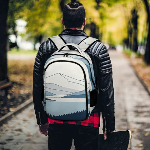 Minimal Mountain Lake Art Backpack For Everyday Carry Unisex shown outdoors on person wearing black jacket