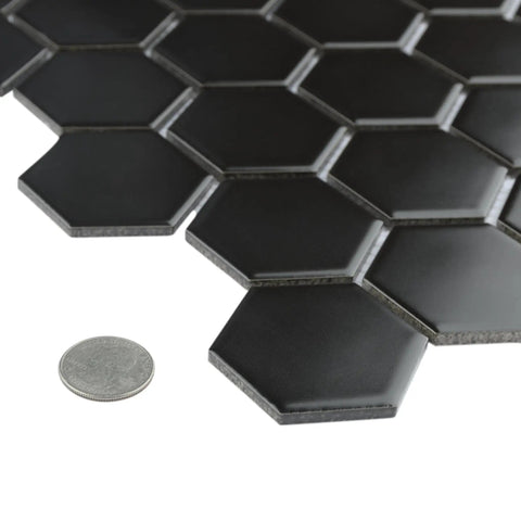 2-Inch Hex Matte Black Porcelain Mosaic Tile For Floors And Walls Mesh Mounted 11.13 x 12.63 Inches with coin for scale.