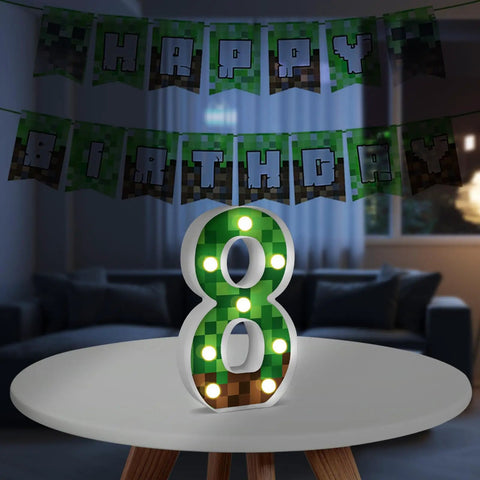 8.5 Inch Pixel Game Light Up Number 8 on table with pixel pattern, Happy Birthday sign, retro arcade style party atmosphere