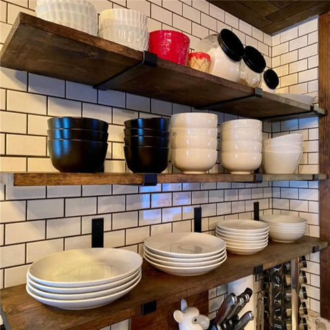 Badass Heavy Duty Metal Wall Shelf Brackets With Lip Slick Industrial Diy Floating Shelf Support System Black Anti Rust Finish Straight Up Reliable Mounting Hardware 2 Pack supporting kitchen plates and bowls in a rustic setting.