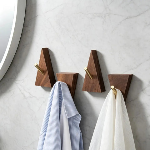 Solid Black Walnut Triangle Wall Hooks With Brushed Brass Caps, Heavy Duty Entryway Coat Rack holding shirts.